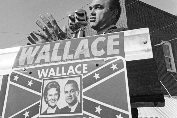 FILE - Alabama Gov. George C. Wallace gestures as he makes an election campaign speech for his wife, Lurleen, Nov. 8, 1966, in Wetumpka, Ala. Republican presidential candidates will debate Wednesday, Dec. 6, 2023, within walking distance of where Wallace staged his “stand in the schoolhouse door” to oppose the enrollment of Black students at the University of Alabama during the Civil Rights Movement. (AP Photo/LG, File)