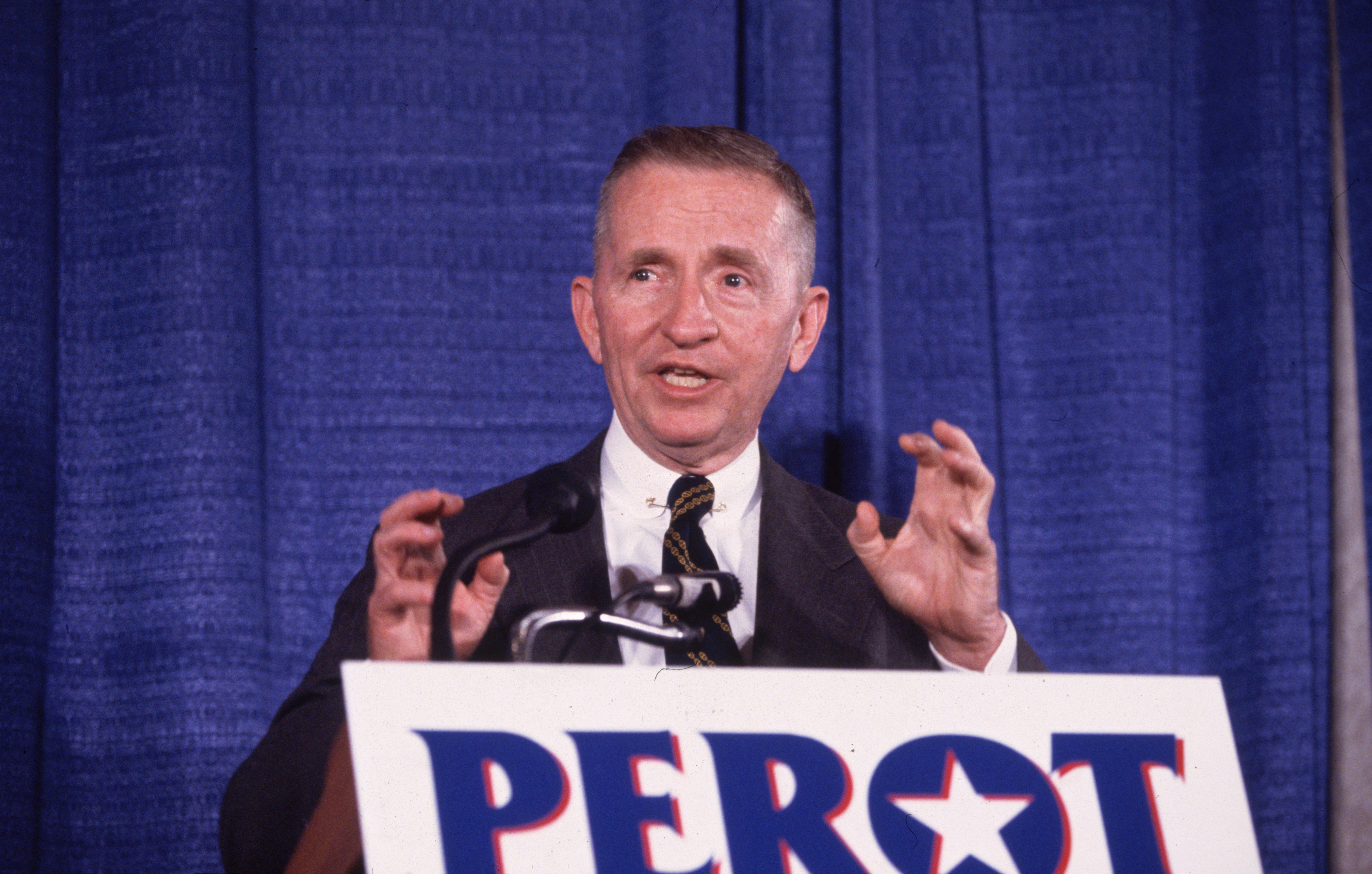 American businessman and politician Ross Perot, undeclared candidate for president, speaking and gesticulating at a podium during a press conference, Annapolis, Maryland.