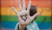 Woman with transgender symbol on her hand.