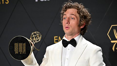 A picture of actor Jeremy Allen White holding his award for best actor in a comedy series at the Emmy awards