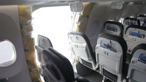 A view from inside the cabin of a plane with a section from the side of the vehicle missing