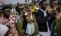 Members of a community brass band parade the streets while playing music at the Bwaise informal settlement in Kampala.