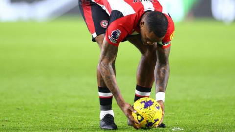 Ivan Toney of Brentford adjusts the position of the ball for his free kick during the Premier League match between Brentford FC and Nottingham Forest