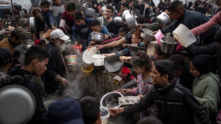 Palestinians line up for a free meal in Rafah, Gaza Strip