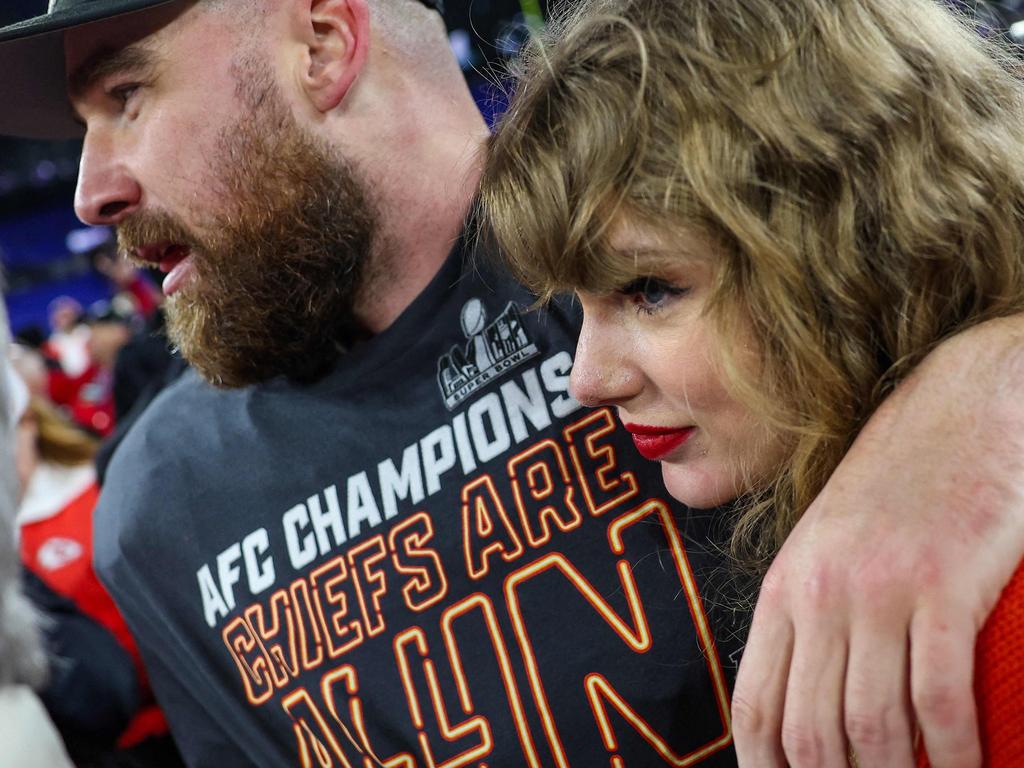 (FILES) Travis Kelce #87 of the Kansas City Chiefs (L) celebrates with Taylor Swift after defeating the Baltimore Ravens in the AFC Championship Game at M&T Bank Stadium on January 28, 2024 in Baltimore, Maryland. You knew Taylor Swift was influential, but Republicans are now crediting the singer with James-Bond-villain-level powers in a wacky conspiracy theory claiming the singer's romance with NFL star Travis Kelce is really a plot to rig the Super Bowl and get President Joe Biden reelected. The relationship between the pop powerhouse and the Kansas City Chiefs tight end has gripped the nation for weeks, with TV cameras repeatedly panning from the field during the team's surging NFL season to a cheering Swift in the stands. (Photo by Patrick Smith / GETTY IMAGES NORTH AMERICA / AFP)