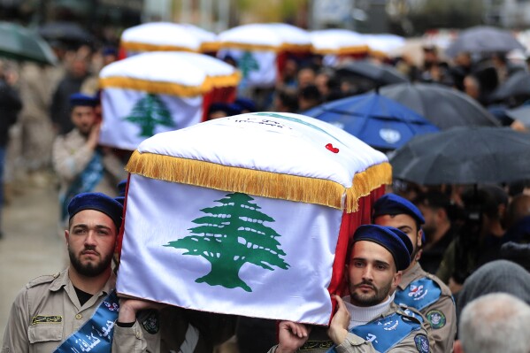 Mourners carry coffins of seven civilians from a one family who were killed in a building by an Israeli airstrike on Wednesday night, during their funeral procession, in Nabatiyeh town, south Lebanon, Saturday, Feb. 17, 2024. The fatalities marked a significant escalation in more than four months of cross-border exchanges, triggered by the outbreak of the Israel-Hamas war in Gaza. (AP Photo/Mohammed Zaatari)