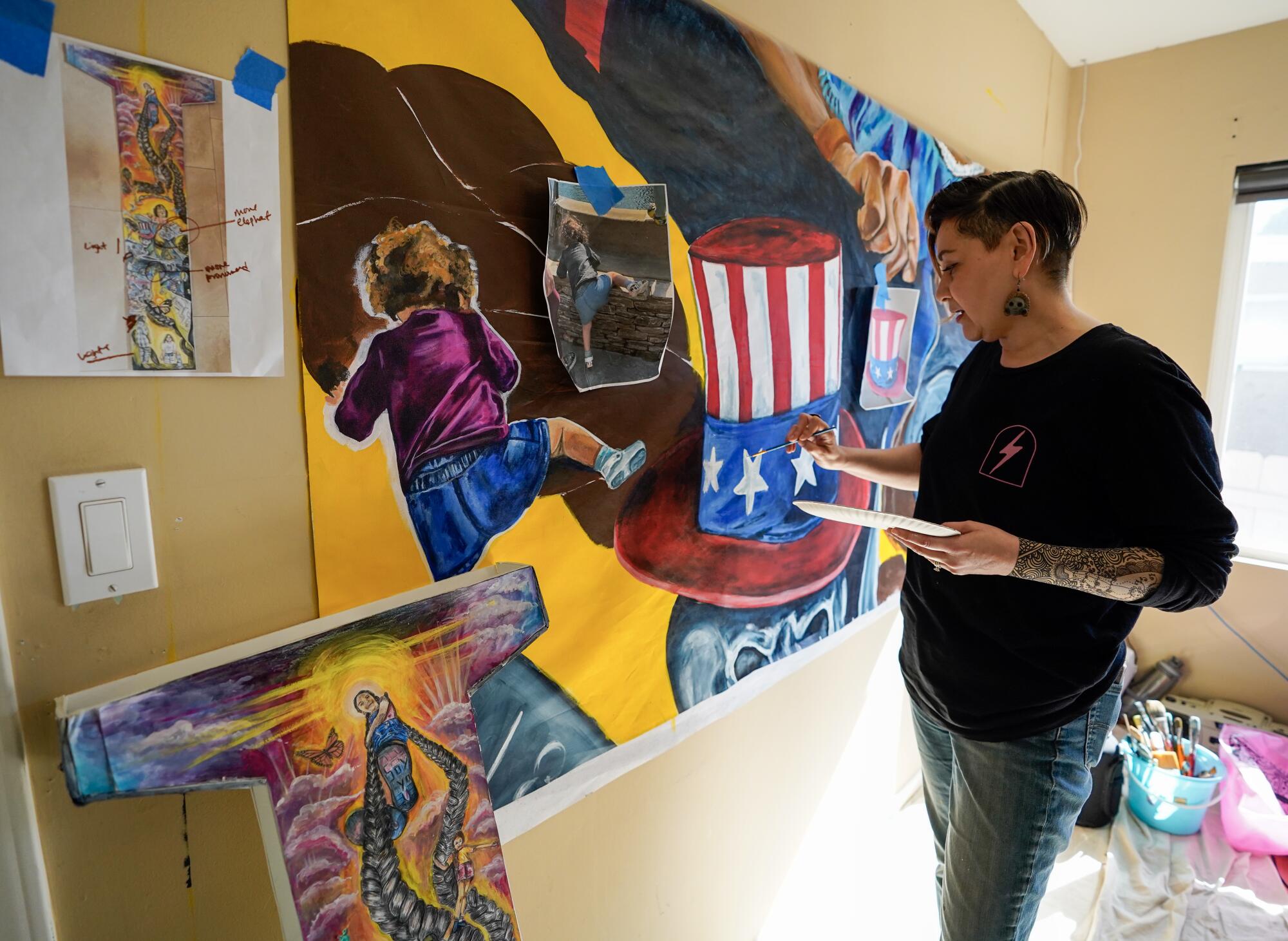 Berenice Badillo works out of her home studio in Encanto. The canvases will later be installed to form the mural.