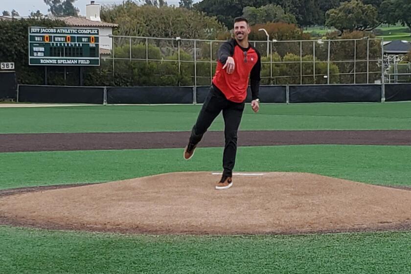 Former major-league pitcher Kyle Zimmer throws out the ceremonial first pitch at the La Jolla High alumni baseball game.