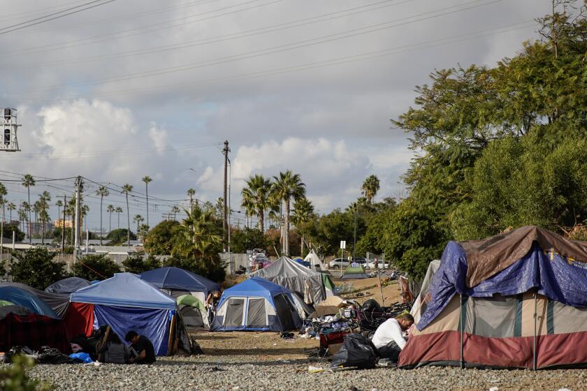 San Diego, CA - November 29: The scene at a homeless camp off Palomar Street and Industrial Blvd. Tents next to the trolley tracks in Chula Vista on Wednesday, Nov. 29, 2023 in San Diego, CA. (Alejandro Tamayo / The San Diego Union-Tribune)