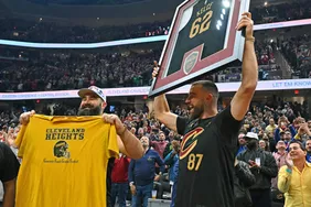Jason Kelce and Travis Kelce wave to the fans during the first quarter of the game between the Cleveland Cavaliers and the Boston Celtics at Rocket Mortgage Fieldhouse on March 05, 2024 in Cleveland, Ohio. 