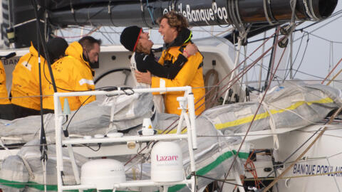 Clarisse Cremer (left) celebrates with her husband at the finish of the last Vendee Globe