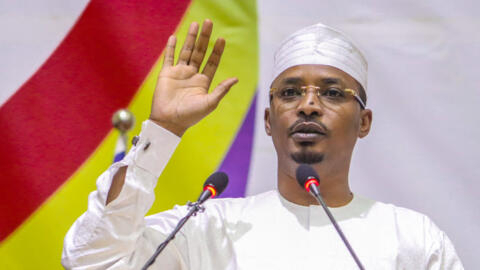 Mahamat Idriss Deby raises his hand as he is sworn in as Chad's transitional president, in NDjamena on October 10, 2022.