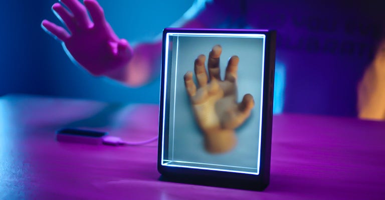 A holographic seems to project an image of a human hand. 