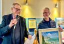Auctioneer, John Nelson, left, with artist Chris Gillies and his oil painting of 'Binnel Bay' Image: Pamela Parker