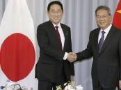 Japan's Fumio Kishida (L) met with Chinese Premier Li Qiang ahead of a trilateral summit in Seoul. (AP PHOTO)
