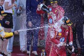 Australia's Oscar Piastri (l), helped by Carlos Sainz, showers Charles Leclerc with champagne. (AP PHOTO)