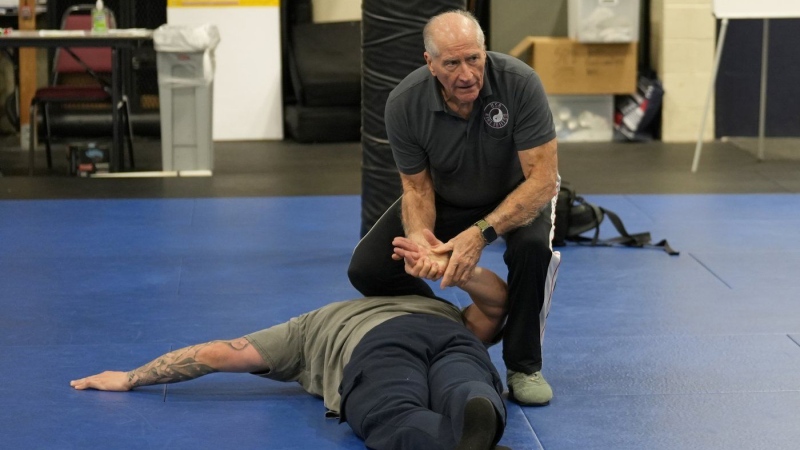 Instructor Dave Rose demonstrates a prone handcuffing position on a student during an Arrest & Control Instructor course in Sacramento, Calif., on Thursday, Jan. 18, 2024. (Rich Pedroncelli / The Associated Press)