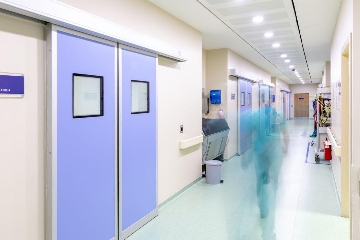 Figure in motion in an operating room corridor