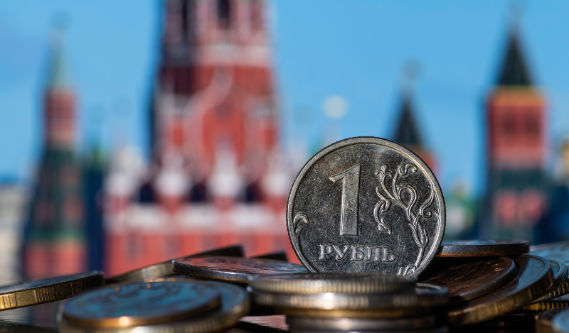 Close up of a Russian coin with the Kremlin in the background