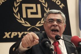 Golden Dawn party leader Nikos Michaloliakos speaks during a news conference [File: Petros Giannakourism/AP Photo]