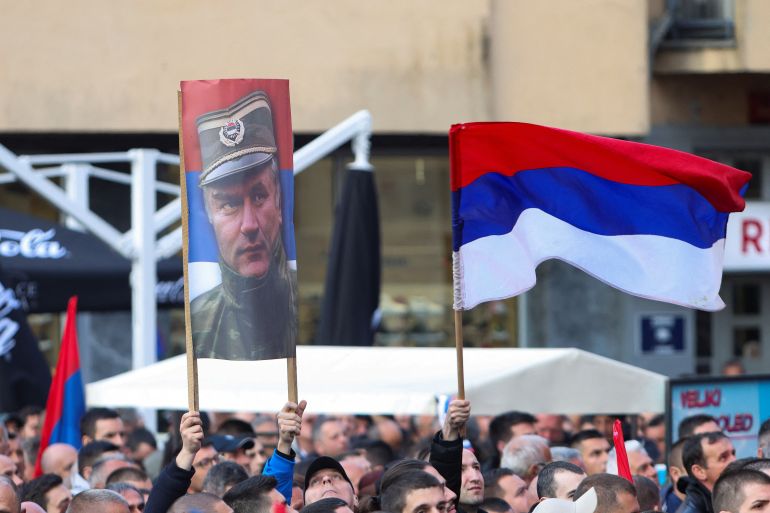 A person holds a banner with a photo of convicted war criminal Ratko Mladic as Bosnian Serbs protest against the resolution on the genocide in Srebrenica which is to be adopted by the United Nations General Assembly in early May, in Banja Luka, Bosnia and Herzegovina, April 18, 2024.REUTERS/Amel Emric