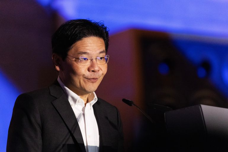 Lawrence Wong. He is wearing a suit and a white, open-necked shirt