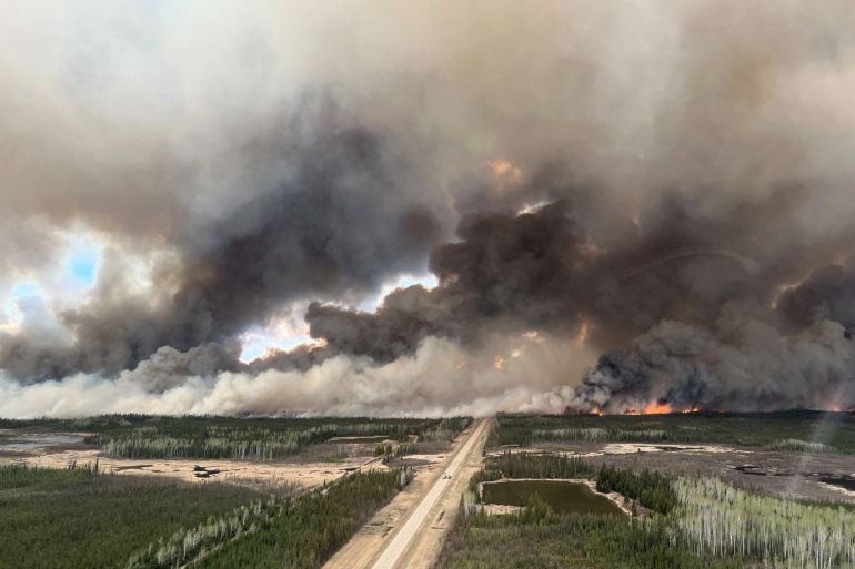 Smoke rises from a wildfire in the Northwest Territories, Canada
