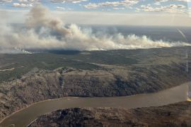A picture shows smoke rising from wildfire MWF017 on the south side of the Athabasca River valley near Fort McMurray in the province of Alberta, Canada, on May 10 [Alberta Wildfire/Handout via Reuters]