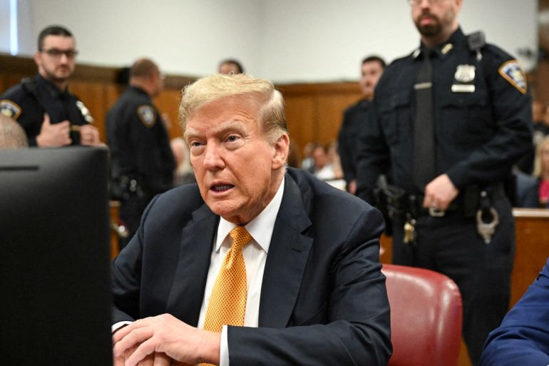 Former US President Donald Trump sits in court