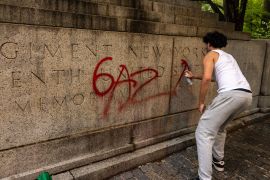 A pro-Palestine protester writes Gaza on a memoriam near Central Park during a march on the outskirts of the Met Gala [Alex Kent/Getty Images via AFP]