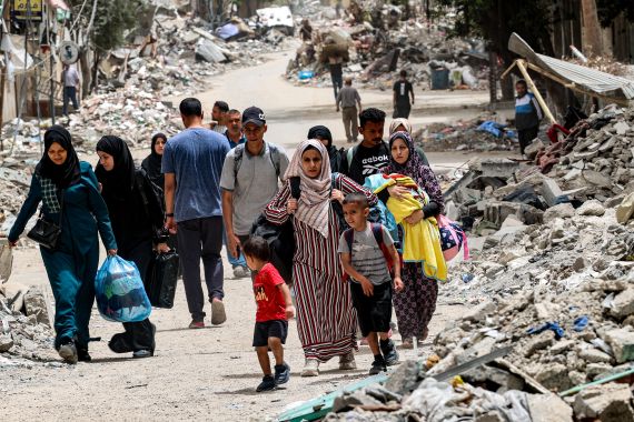 Displaced Palestinians evacuate from the Tal al-Zaatar camp for Palestinian refugees in the northern Gaza Strip on May 11