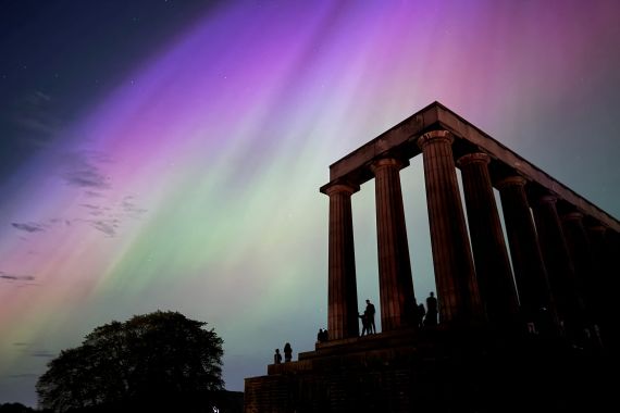 This handout photo taken and released by Jacob Anderson shows the northern lights or aurora borealis during a solar storm over the National Monument of Scotland in Edinburgh on May 10