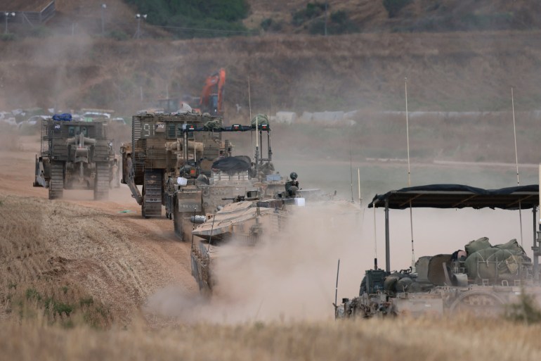 Israeli military vehicles roll near the border with the Gaza Strip on May 12, 2024, amid the ongoing conflict between Israel and the Palestinian Hamas movement. (Photo by Menahem KAHANA / AFP)
