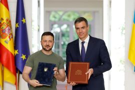 From left, Ukrainian President Volodymyr Zelenskyy and Prime Minister Pedro Sanchez with a security deal they signed at Moncloa Palace in Madrid [Oscar Del Pozo/AFP]