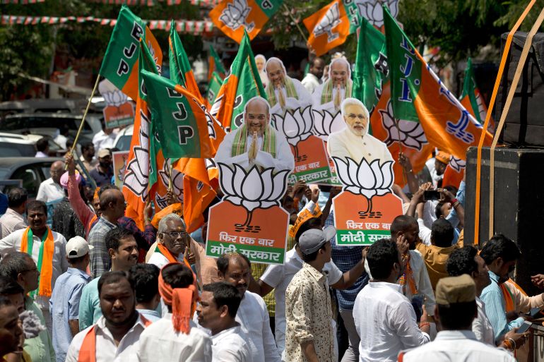 Supporters of India's ruling Bharatiya Janata Party participate in a victory rally after the party won four seats in Telangana state in Hyderabad, India