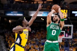 Boston Celtics forward Jayson Tatum (0) shoots over Indiana Pacers forward Aaron Nesmith (23) during Game 3 of the NBA Eastern Conference finals [Michael Conroy/AP]