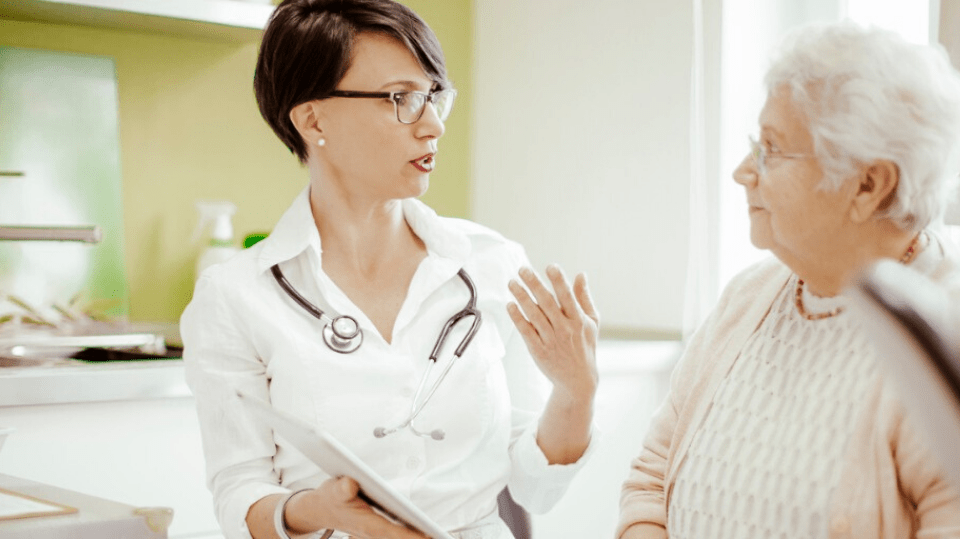 Physician talking to elderly patient