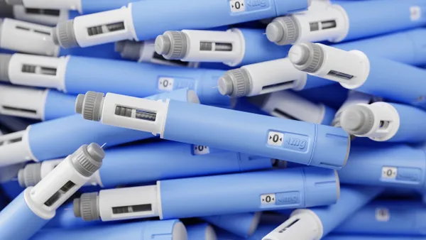 A large group of dosing pens for subcutaneous injection of anti-obesity medication piled in a heap.