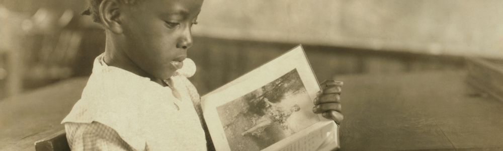 young black girl reading a book