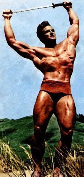 Steve Reeves poses with sword.