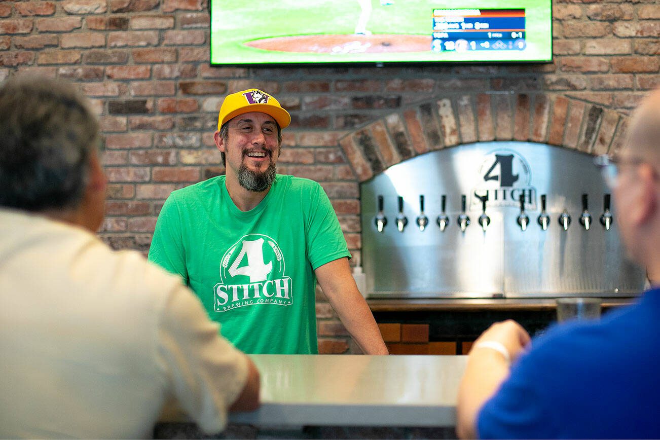 Matt Pereira, owner and brewer at 4 Stitch Brewing Company, talks with a couple regulars at the bar on Friday, June 23, 2023, in Mill Creek, Washington. (Ryan Berry / The Herald)