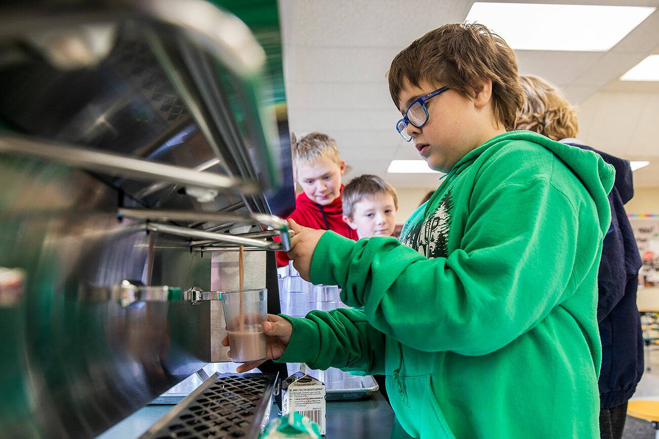 Darrington Elementary School fourth grader Brayden Parris, 9, fills up his cup with chocolate milk from one of the schools new milk dispenser during lunch on Monday, Nov. 20, 2023 in Darrington, Washington. (Olivia Vanni / The Herald)