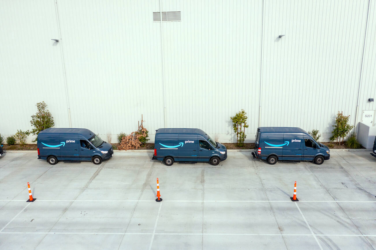 Amazon delivery vans at a shipping facility in Chatsworth, Calif., on Jan. 12, 2022. The company has big plans to turn its delivery fleet green, but very few of the vehicles are made right now. (Roger Kisby/The New York Times)