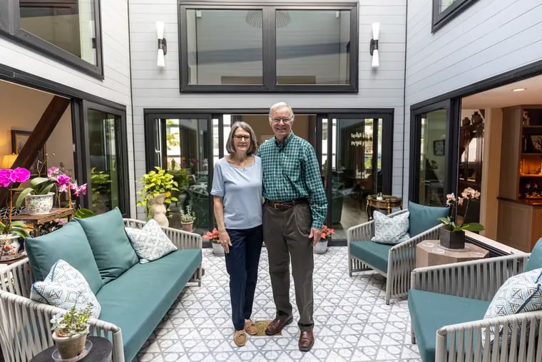 Ed and Karen D’Alba in their atrium. The double-wide brick home was built as a livery stable in 1868 on a block of new, three-story rowhouses in Spring Garden.