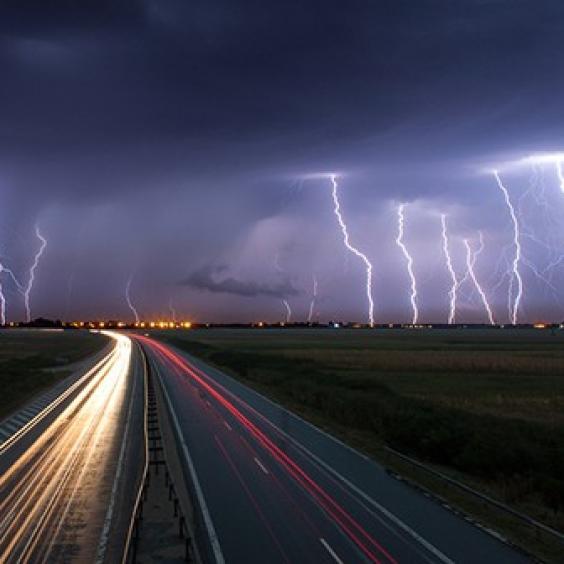 Lightning strikes near a highway