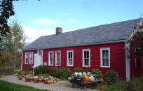 Red Building with pumpkins and gourds in front