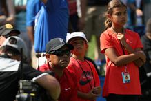 Tiger Woods looks on with his children Sam and Charlie during the final round of the 2016 Quicken Loans National