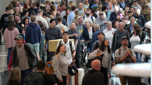 Travelers walk through Salt Lake City International Airport Friday, May 24, 2024, in Salt Lake City. A record number of Americans are expected to travel over the 2024 Memorial Day holiday. (AP Photo/Rick Bowmer)