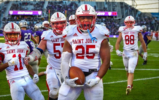 Kai Barber celebrates a touchdown for St. John's during the second half of the game Saturday, Oct. 19, 2019, against St. Thomas at Allianz Field in St. Paul. The Johnnies won the 89th meeting of the two teams 38-20.