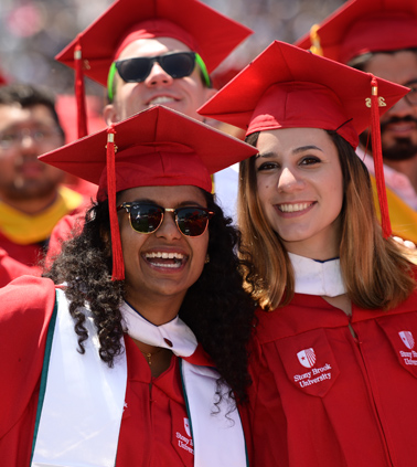 A group of happy Stony Brook graduates at Commencement ceremony